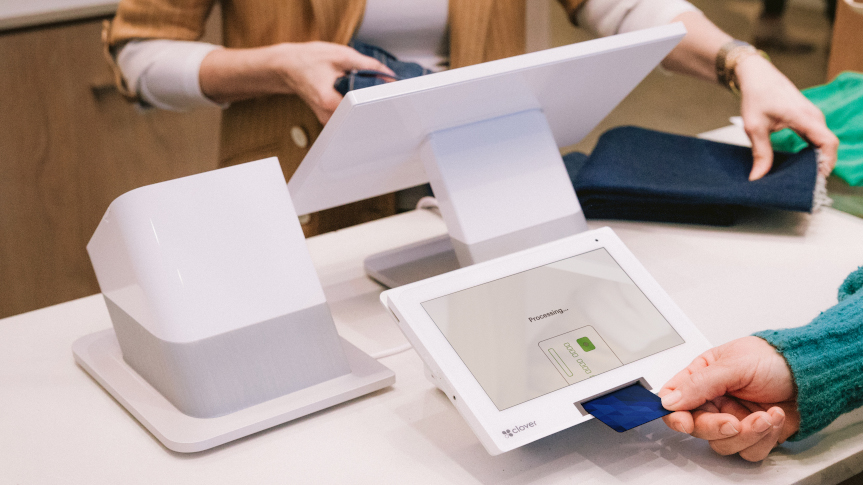 Customer inserting a payment card into a Clover counter system