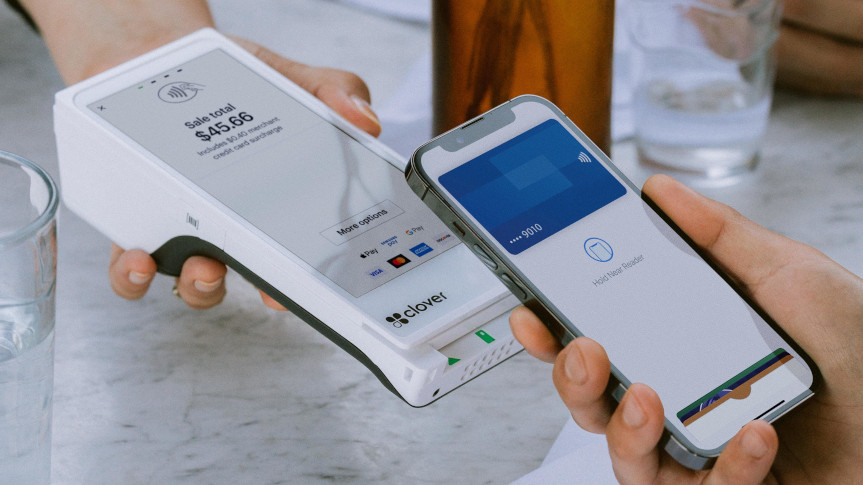 Customer paying on a Clover Flex with a phone wallet at a table